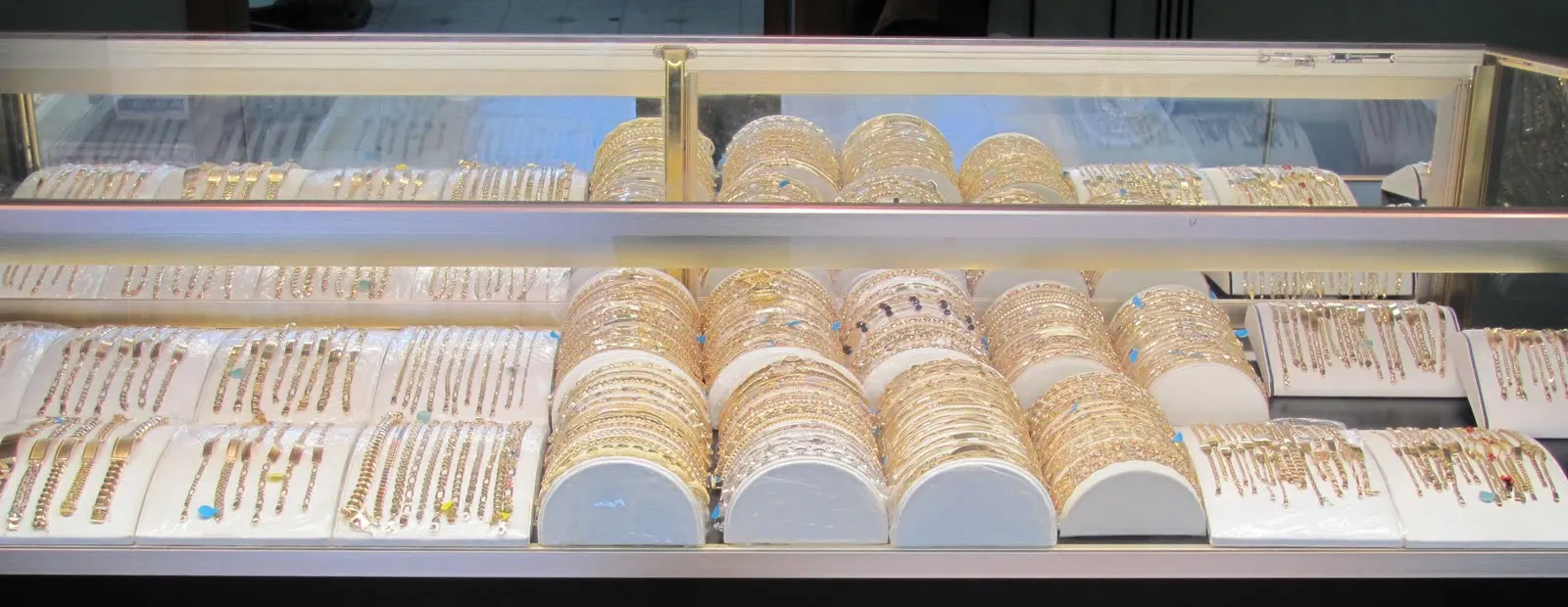 A glass case of gold bracelets and bangles at Tito's Jewelry